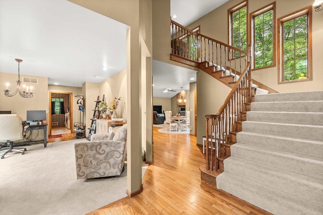 2621 Russet Dr, Plover, WI 54467 - living room with a chandelier, stairs, wood-type flooring, a desk, and recessed lighting