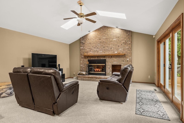 2621 Russet Dr, Plover, WI 54467 - carpeted living room with a skylight, vaulted ceiling, ceiling fan, and a fireplace