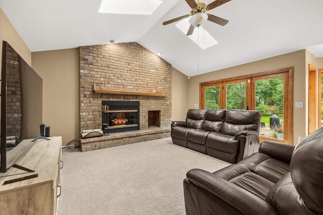 2621 Russet Dr, Plover, WI 54467 - living area featuring a skylight, vaulted ceiling, carpet, a brick fireplace, and ceiling fan