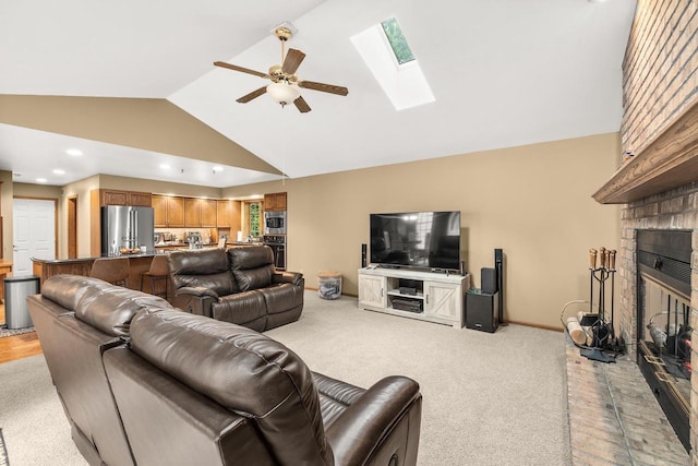 2621 Russet Dr, Plover, WI 54467 - living room with a skylight, ceiling fan, light carpet, a fireplace, and recessed lighting