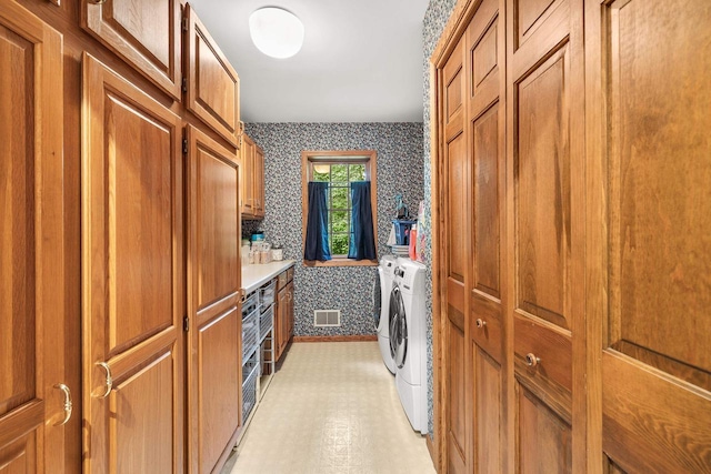2621 Russet Dr, Plover, WI 54467 - washroom with washing machine and dryer, cabinet space, wallpapered walls, and light flooring