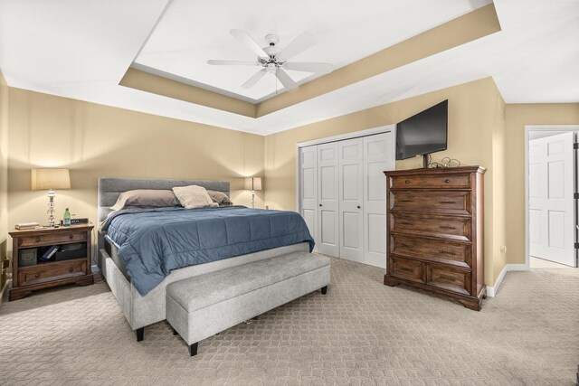 2621 Russet Dr, Plover, WI 54467 - bedroom featuring light carpet, a raised ceiling, a closet, and ceiling fan