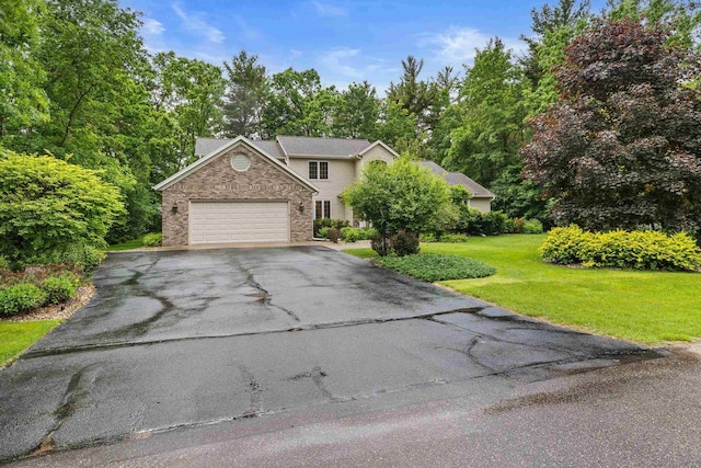 2621 Russet Dr, Plover, WI 54467 - view of front facade featuring driveway, an attached garage, a front yard, and stone siding