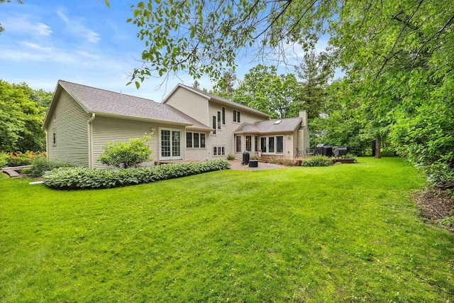 2621 Russet Dr, Plover, WI 54467 - rear view of property featuring a lawn, a chimney, and a patio