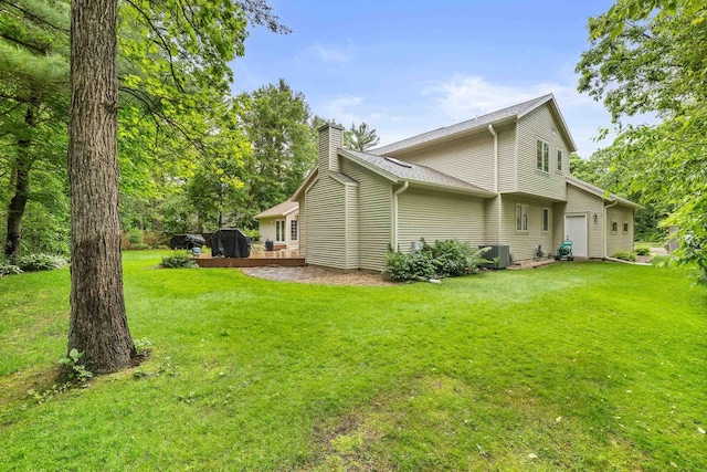 2621 Russet Dr, Plover, WI 54467 - view of home's exterior featuring a chimney, a lawn, and a wooden deck