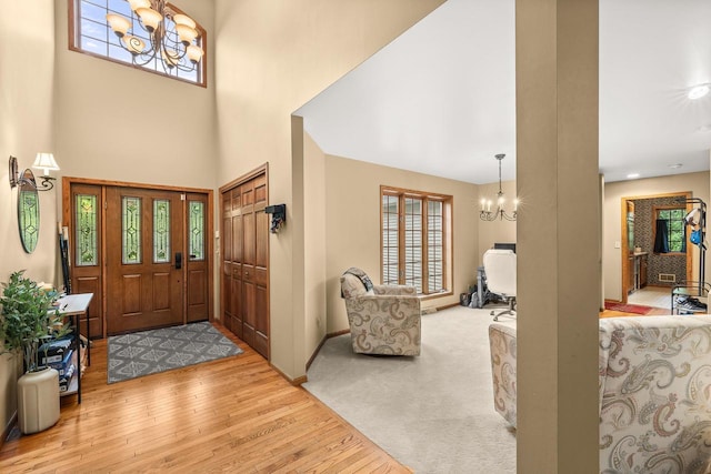 2621 Russet Dr, Plover, WI 54467 - foyer entrance with a chandelier, wood finished floors, and a towering ceiling