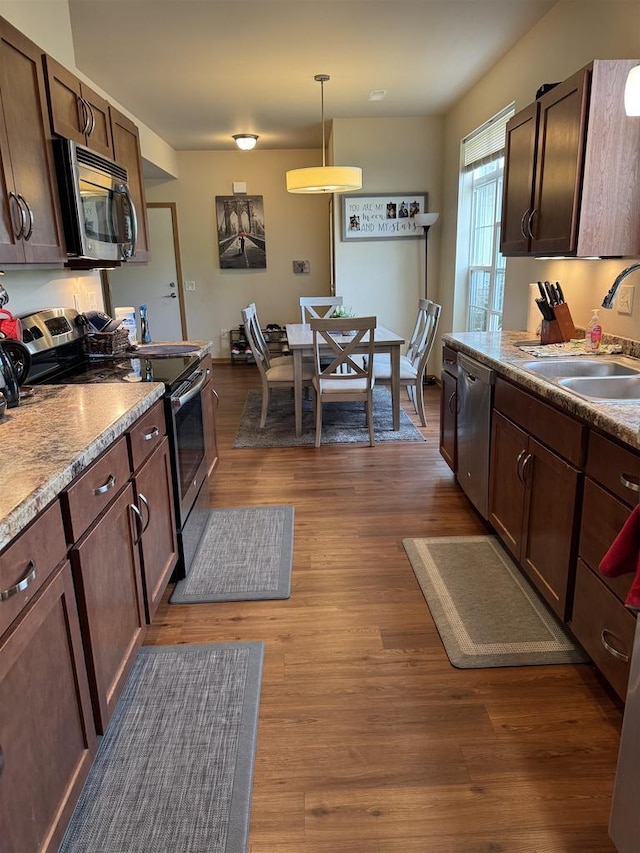 4868-4882 Innovation Dr, Deforest, WI 53532 - kitchen with appliances with stainless steel finishes, dark wood-style floors, pendant lighting, and dark brown cabinetry