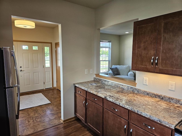 4868-4882 Innovation Dr, Deforest, WI 53532 - kitchen with freestanding refrigerator, dark wood-style floors, dark brown cabinets, and light stone countertops