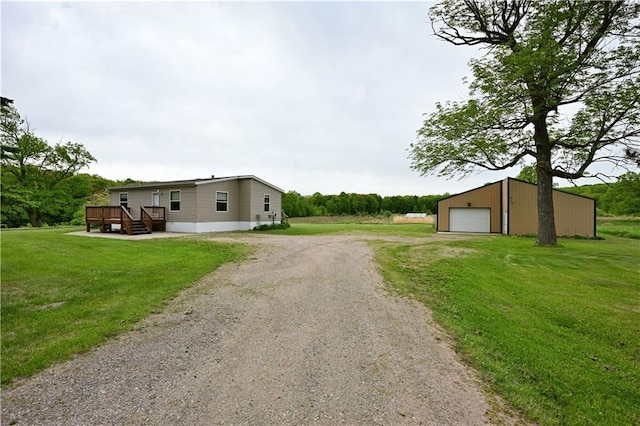 2329 Sand Rd, Shell Lake, WI 54871 - view of home's exterior with driveway, a detached garage, an outbuilding, and a yard