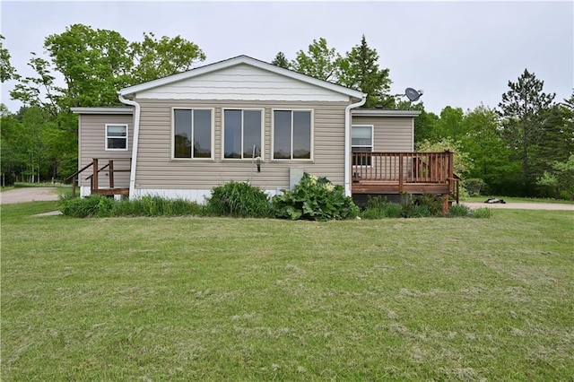 2329 Sand Rd, Shell Lake, WI 54871 - rear view of house featuring a lawn and a wooden deck