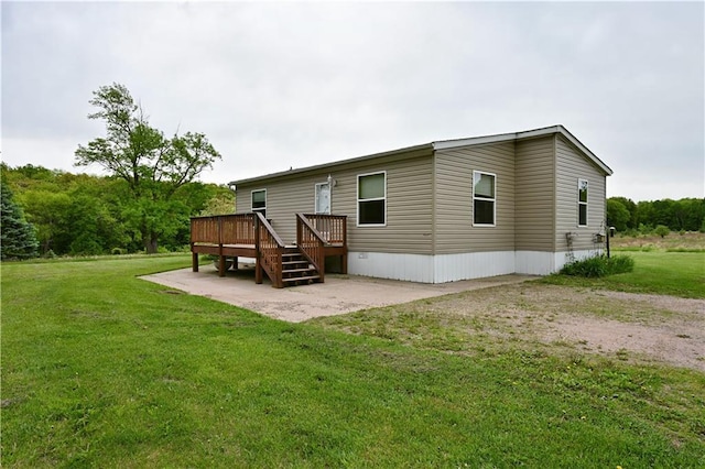 2329 Sand Rd, Shell Lake, WI 54871 - back of property featuring a wooden deck, a patio area, and a yard
