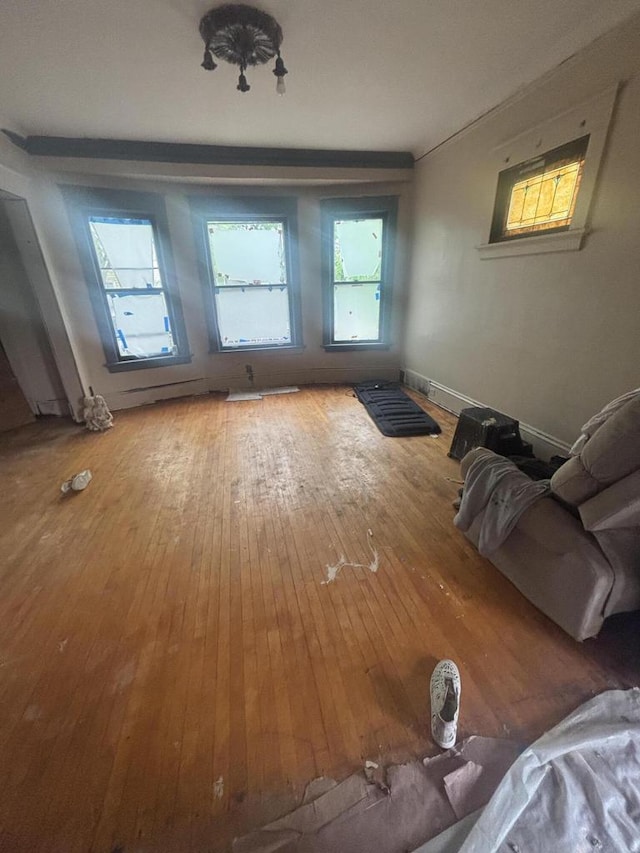3225 N 24th Pl Unit 3227, Milwaukee, WI 53206 - unfurnished living room featuring hardwood / wood-style floors and baseboards