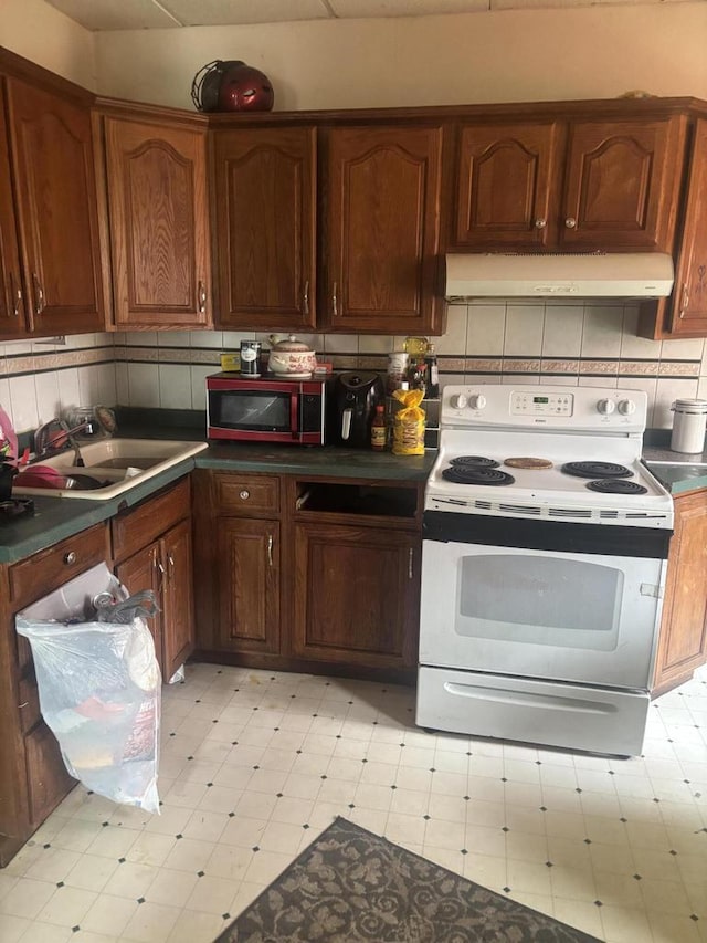 3225 N 24th Pl Unit 3227, Milwaukee, WI 53206 - kitchen with white electric range, light flooring, range hood, and stainless steel microwave