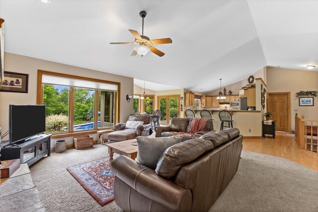 110 Chestnut Way, North Prairie, WI 53153 - living room with a ceiling fan, vaulted ceiling, light wood finished floors, and a chandelier