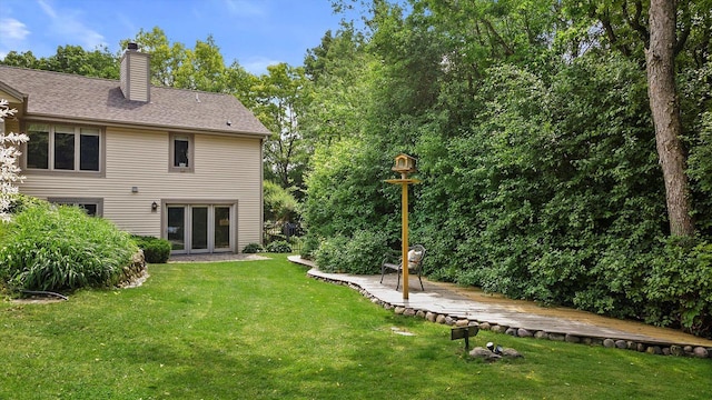 110 Chestnut Way, North Prairie, WI 53153 - rear view of property with a deck, a chimney, and a yard