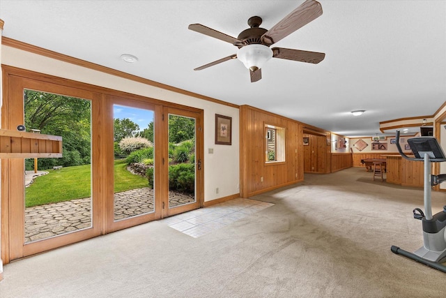 110 Chestnut Way, North Prairie, WI 53153 - unfurnished living room with carpet floors, ornamental molding, wooden walls, and a ceiling fan