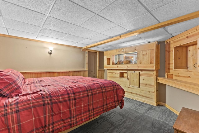 110 Chestnut Way, North Prairie, WI 53153 - carpeted bedroom with wood walls, a paneled ceiling, and wainscoting