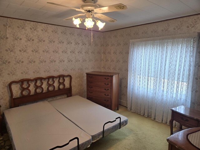 624 Depot St, Manawa, WI 54949 - bedroom featuring light colored carpet, ceiling fan, and wallpapered walls