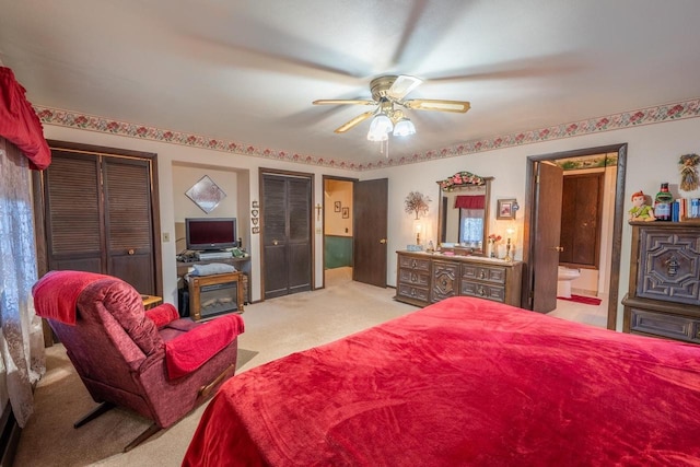 8420 Southview Dr, Crandon, WI 54520 - bedroom with light colored carpet, two closets, connected bathroom, and a ceiling fan