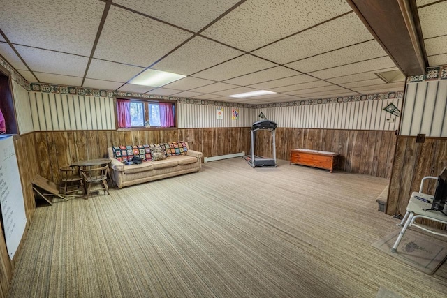 8420 Southview Dr, Crandon, WI 54520 - living area with carpet, baseboard heating, wood walls, and a paneled ceiling