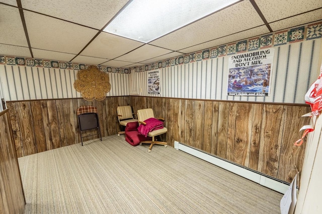 8420 Southview Dr, Crandon, WI 54520 - sitting room with a paneled ceiling, a baseboard heating unit, carpet flooring, wainscoting, and wood walls