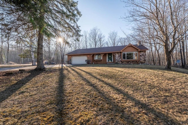 8420 Southview Dr, Crandon, WI 54520 - ranch-style home with a chimney, a garage, and driveway