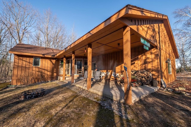 8420 Southview Dr, Crandon, WI 54520 - rear view of property with a fire pit and a patio
