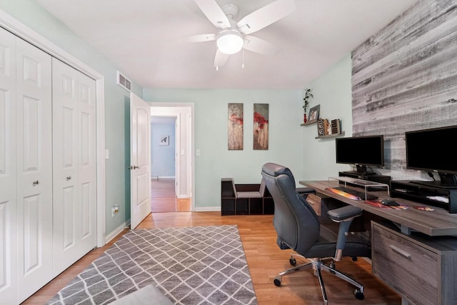 1434 Alcan Dr, Menasha, WI 54952 - office space with a ceiling fan, wood finished floors, an accent wall, and wood walls