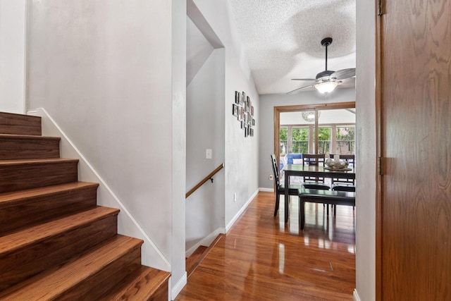 1434 Alcan Dr, Menasha, WI 54952 - stairs with ceiling fan, a textured ceiling, and wood finished floors