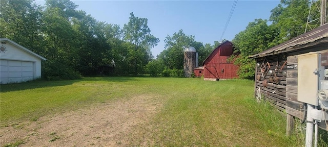 N3598 Nichols Rd, Black River Falls, WI 54615 - view of grassy yard with a barn, an outbuilding, and a garage