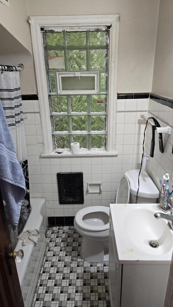 3240 N Richards St Unit 3242, Milwaukee, WI 53212 - bathroom featuring tile walls, vanity, and a wainscoted wall