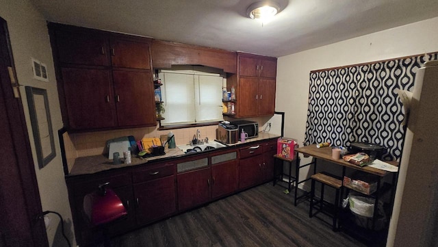 3240 N Richards St Unit 3242, Milwaukee, WI 53212 - kitchen with dark wood finished floors, dark countertops, and decorative backsplash