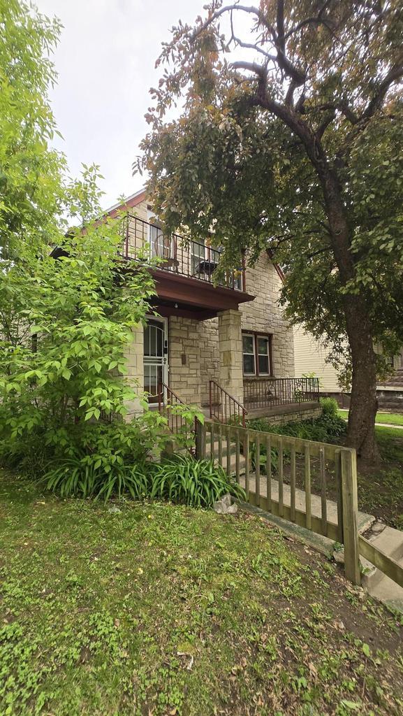 3240 N Richards St Unit 3242, Milwaukee, WI 53212 - view of home's exterior with stone siding and a balcony