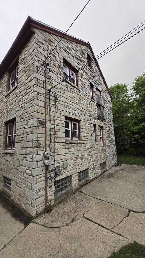 3240 N Richards St Unit 3242, Milwaukee, WI 53212 - view of home's exterior with stone siding