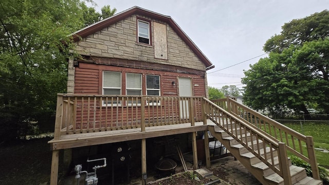 3240 N Richards St Unit 3242, Milwaukee, WI 53212 - rear view of property featuring stone siding, a deck, and stairway