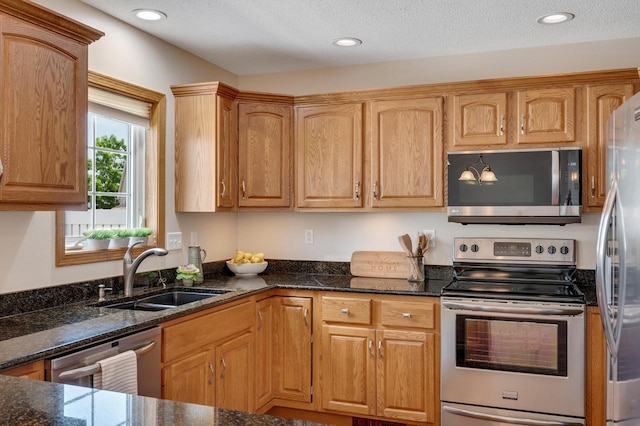2641 13th Ct, La Crosse, WI 54601 - kitchen featuring appliances with stainless steel finishes, dark stone countertops, and recessed lighting