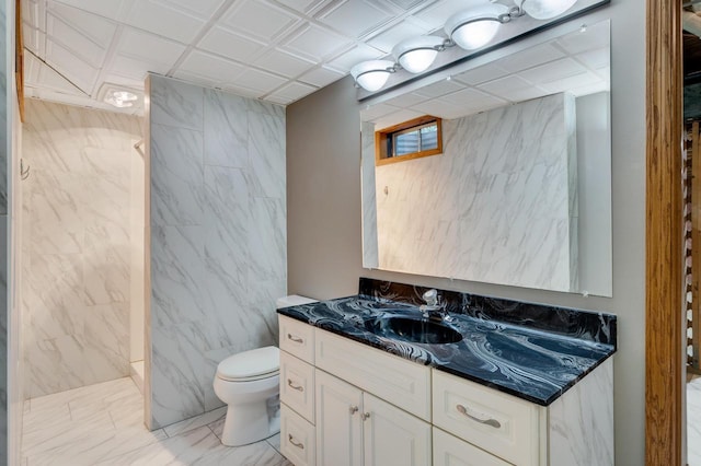 2641 13th Ct, La Crosse, WI 54601 - full bath with vanity, a shower, marble look tile flooring, and tile walls