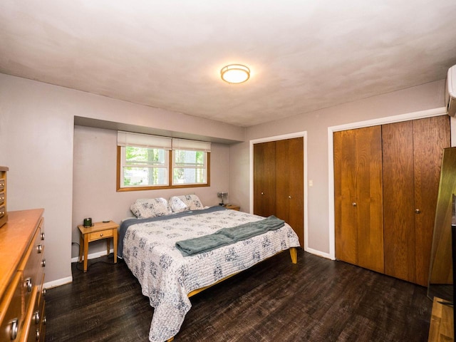 614 Decker Dr, West Bend, WI 53090 - bedroom featuring dark wood-type flooring and multiple closets