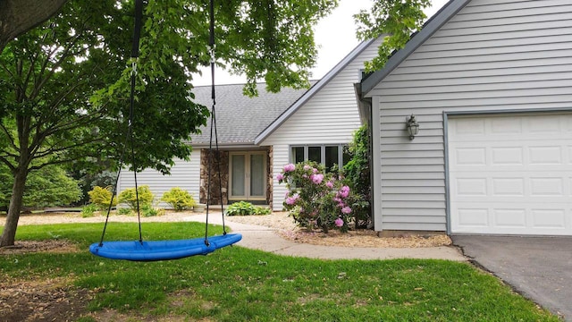 1341 Fieldstone Ct, Neenah, WI 54956 - view of front of house featuring a front yard, an attached garage, and roof with shingles