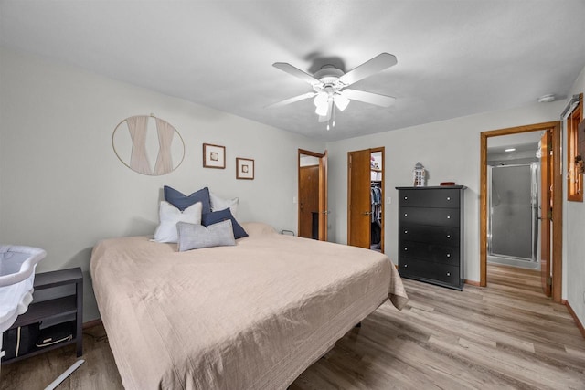 1341 Fieldstone Ct, Neenah, WI 54956 - bedroom with light wood finished floors, ceiling fan, a walk in closet, and a closet