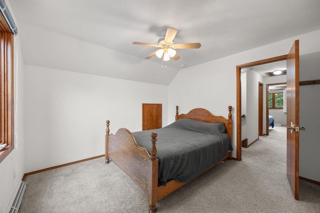 1341 Fieldstone Ct, Neenah, WI 54956 - bedroom with baseboard heating, light carpet, ceiling fan, and vaulted ceiling