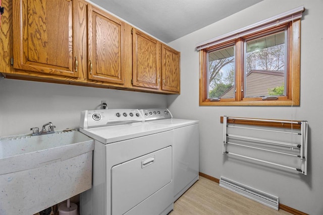 1341 Fieldstone Ct, Neenah, WI 54956 - laundry room featuring washer and dryer, a baseboard heating unit, and cabinet space