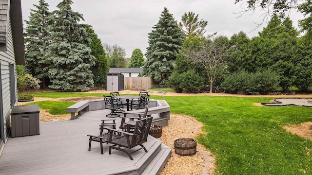 1341 Fieldstone Ct, Neenah, WI 54956 - view of green lawn featuring a storage unit, a deck, and outdoor dining space