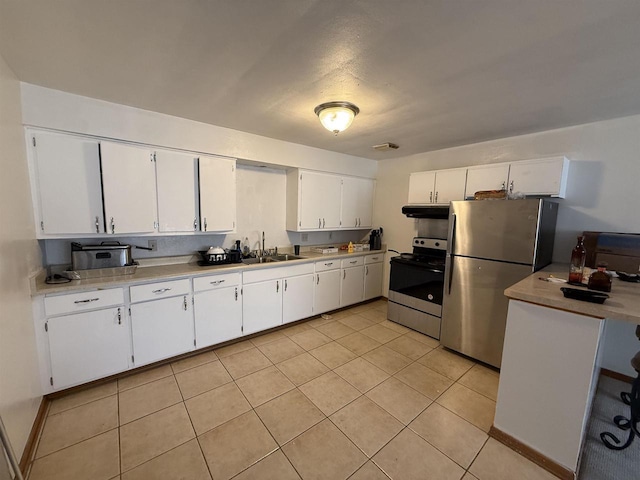 2338 Allied Dr Unit 4, Madison, WI 53711 - kitchen featuring appliances with stainless steel finishes, under cabinet range hood, white cabinetry, light tile patterned floors, and light countertops