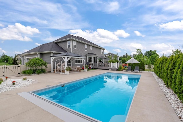 7845 W Mourning Dove Ln, Mequon, WI 53097 - view of pool with a gazebo, a wooden deck, a gate, a patio, and a fenced backyard