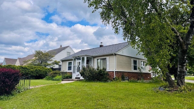 3315 E Allerton Ave, Cudahy, WI 53110 - view of front facade with a front lawn, brick siding, and a chimney