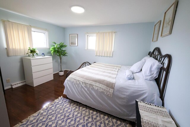 3315 E Allerton Ave, Cudahy, WI 53110 - bedroom featuring a baseboard heating unit and wood finished floors