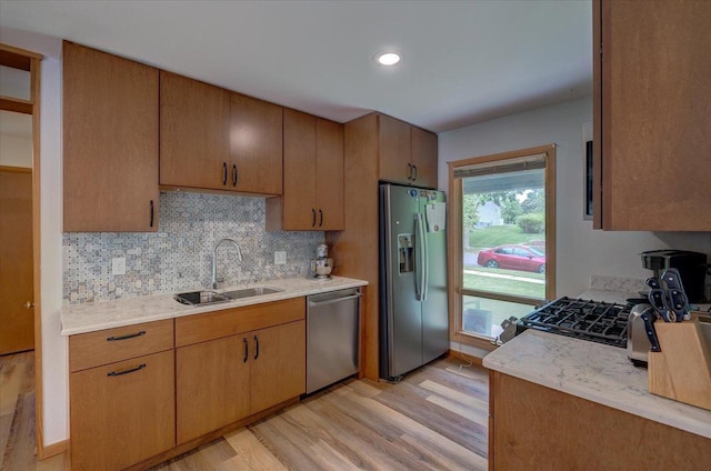 5043 Marathon Dr, Madison, WI 53705 - kitchen with stainless steel appliances, light countertops, light wood-style floors, and tasteful backsplash