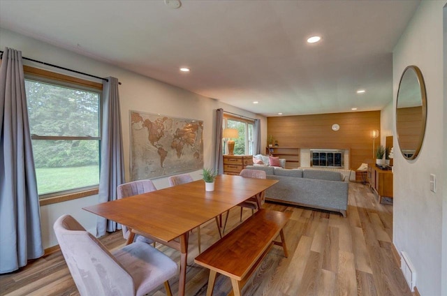 5043 Marathon Dr, Madison, WI 53705 - dining space featuring light wood finished floors, recessed lighting, a fireplace, and wood walls