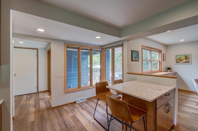 5043 Marathon Dr, Madison, WI 53705 - kitchen featuring light wood-type flooring, recessed lighting, a breakfast bar, and a center island